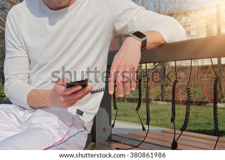 Man using solag charger for mobile phone close up