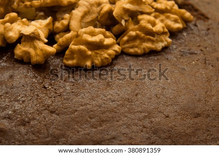 Shelled walnuts on a chocolate biscuit (upper left corner, front view)