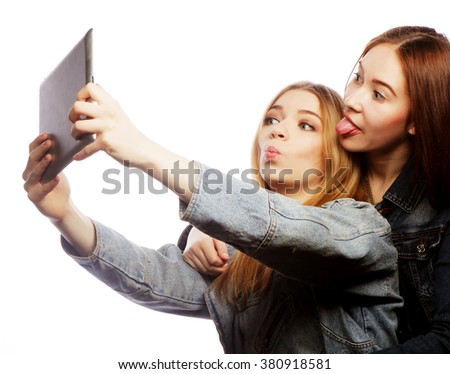 Two pretty young women taking a self portrait 