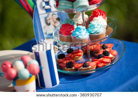 Festive table decorated in a nautical style with a variety of desserts