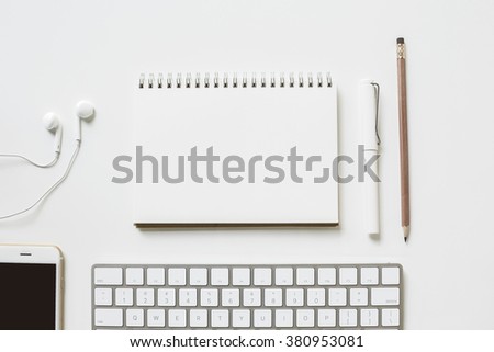 Office table with smartphone and office supply top view, blank paper calendar for text or product display
