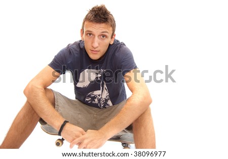 portrait of a skater sitting on his skateboard