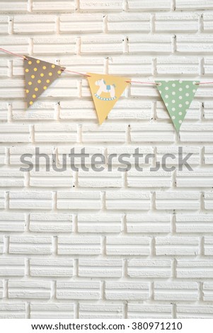 White brick wall decorated by colorful cartoon flag for children for children's room or babyshower party