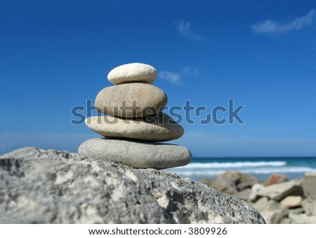 Zen arrangement -Composition of pebble stacks on beach background