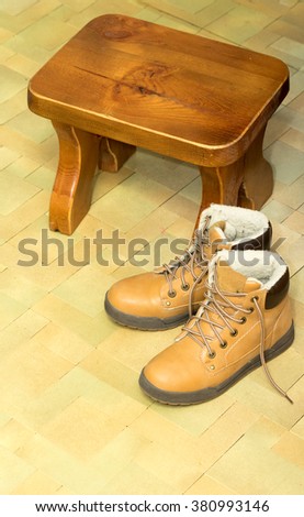 yellow shoes on the floor with a stool