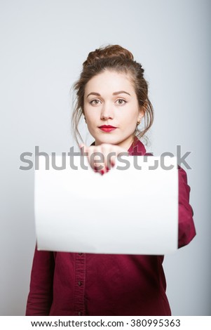 beautiful girl with a clean sheet for inscriptions, isolated on a gray background