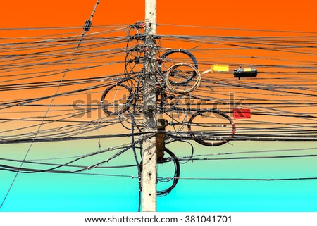 Power pole and wires tangled in twilight time.