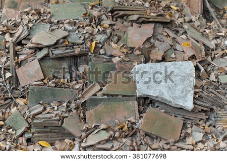 Abandoned or demolished tiles are organised on the ground.