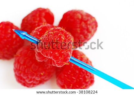 close up of fresh raspberry with toothpick look like heart