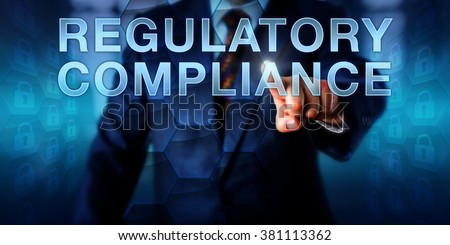 Governance officer is touching REGULATORY COMPLIANCE onscreen. Business metaphor and technology concept for practices of compliance control, operational transparency and IT governance. Royalty-Free Stock Photo #381113362