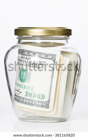 Money in glass jars, isolated on white background