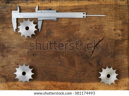 Engineering tools - gears and caliper on wooden table. Success concept. Top view Copy space for text.