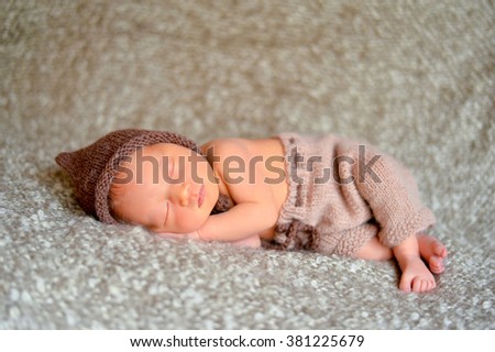 sleeping newborn baby on a blanket