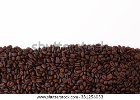 Frame made of grains of black coffee on a white background Royalty-Free Stock Photo #381256033