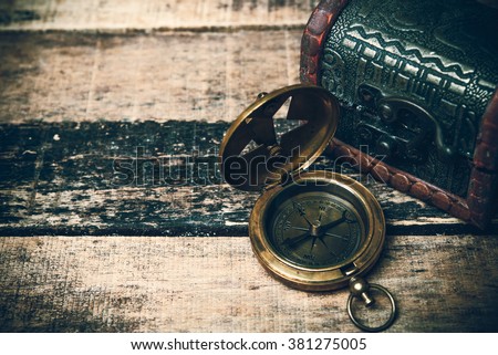 old brass compass on wood table top view