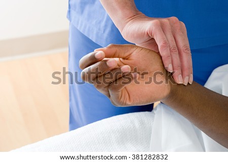Nurse checking patients pulse