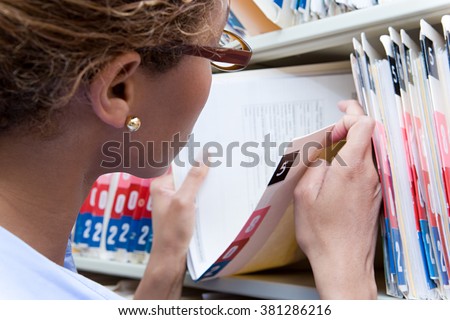 Administrator looking at medical record Royalty-Free Stock Photo #381286216