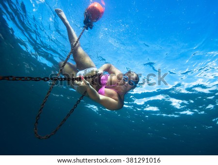 Young woman in clear tropical sea