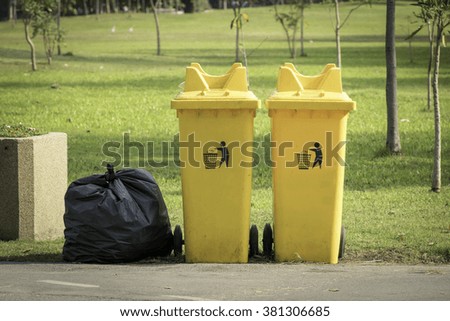 Garbage bags placed beside the bins.