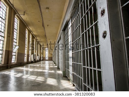 Prison bars and a hallway Royalty-Free Stock Photo #381320083