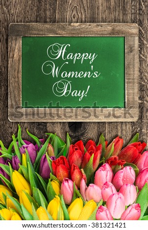 Chalkboard with tulip flowers and sample text Happy Womens Day!