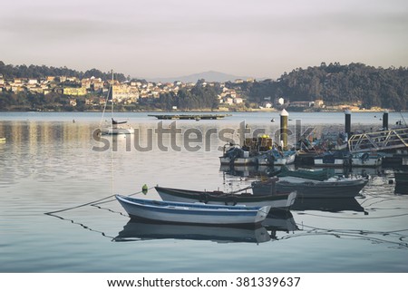 Picture of sunset over several boats in the port of the village sailor named Combarro, in the province of Pontevedra, in Galicia, Spain. Stock photography. 