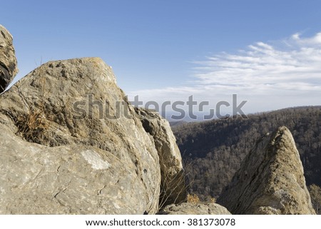 Rocky mountain and valley hill over blue sky with clouds. Copy space