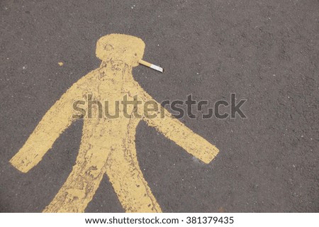 Painting on roadway of walking man with cigarette