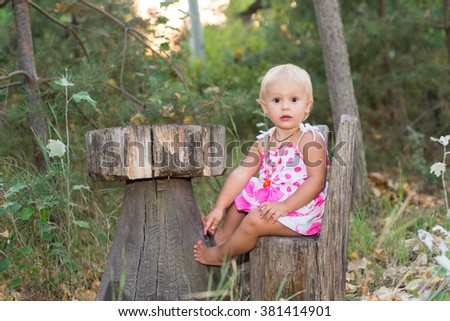 The child, a little girl playing in the woods, summer vacation, education and child development, forest interior, wooden furniture, in anticipation of a meal in a Fairy Tale