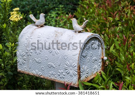 Old vintage white postbox with flowers pattern