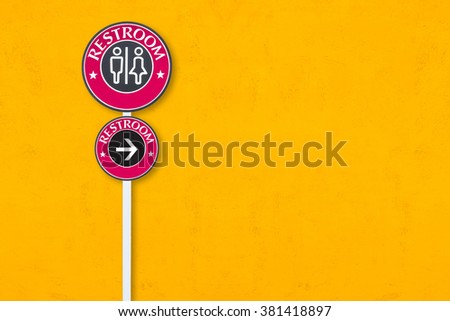 Toilet sign on yellow wall background