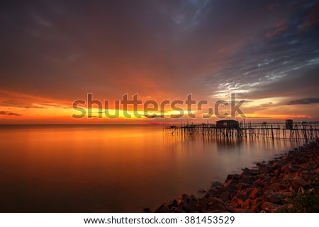 Long exposure image of "langgai" during beautiful sunset , the traditional fishing medium at Malaysia .Image has certain noise and soft focus when view at full resolution