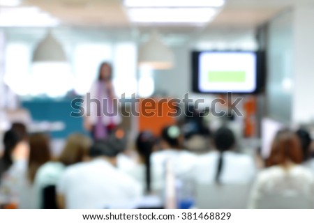 Blurred image of head staff meeting informally with her staffs in morning working day