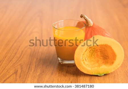 pumpkin juice on wood background
