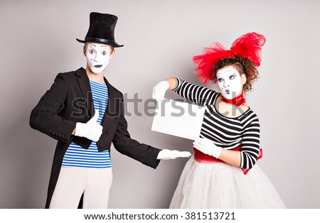 Two mimes with a sign for advertising