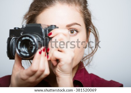 beautiful girl photographed on a vintage camera, isolated on gray background