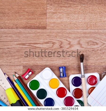 Many new colorful items for creativity lie on a wooden background