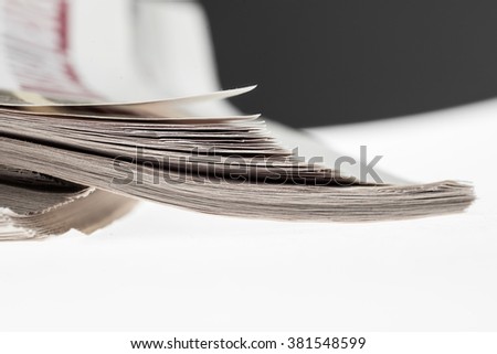 Closeup of stack of newspapers. Assortment of folded newspapers isolated on white. Breaking news, journalism, power of the media, newspaper and magazine ads and subscription concept.