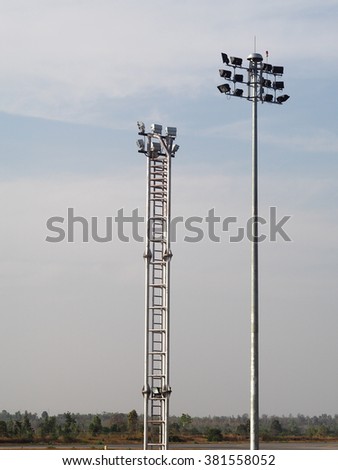 large tall high outdoor powerful spotlights on rod and rigid frame construction with blue sky background in an airport