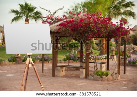 easel on the background of the arbor