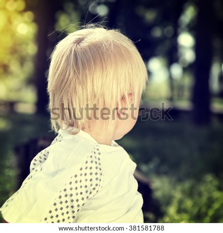 Toned Photo of Child look away at the Summer Park