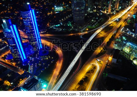 The traffic light trails in the street by modern building New York, Istanbul, London, Dubai, Frankfurt, Paris, Barcelona, Rome, Warsaw, Moscow or other big city