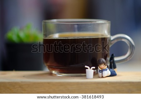 Japanese gashapon toy playing with a glass of  coffee 