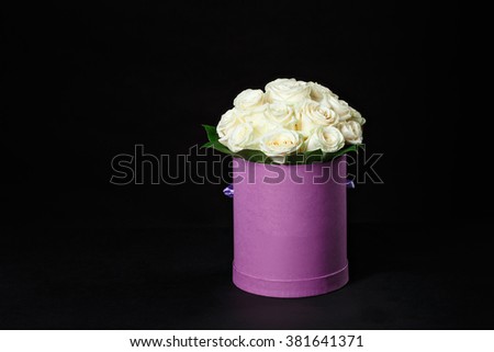 Romantic white roses in a small gift box purple round space for the logo, studio shooting, the spring comes,8 March.