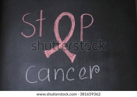 Symbol of Breast Cancer Awareness Ribbon design on blackboard. Photo is for healthcare and medical purpose.