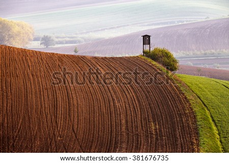 Arable lands in spring. Hunting box in Czech Moravia hills