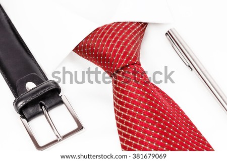  tie knotted double Windsor, leather belt and silver pen