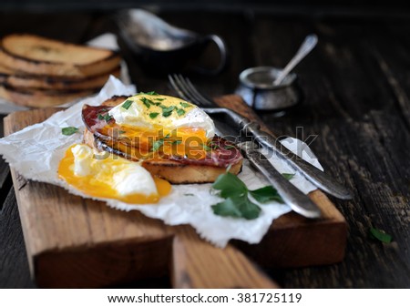 Poached egg with bacon and toaster on paper
