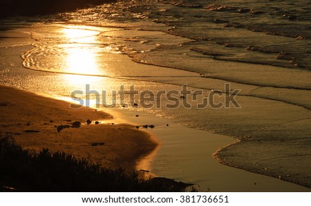 Reflection of beautiful golden sunset in the sea water.Peaceful serene landscape. Nature background. A game of light and shadow.