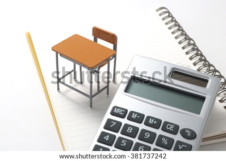 Notebook, calculator,  and miniature desk  / Study or student insurance image